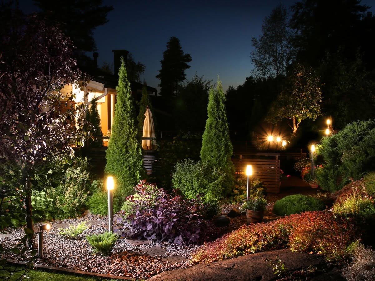 Professionally installed outdoor landscape lighting illuminating a home's walkway and landscaping in Pierce County, WA.