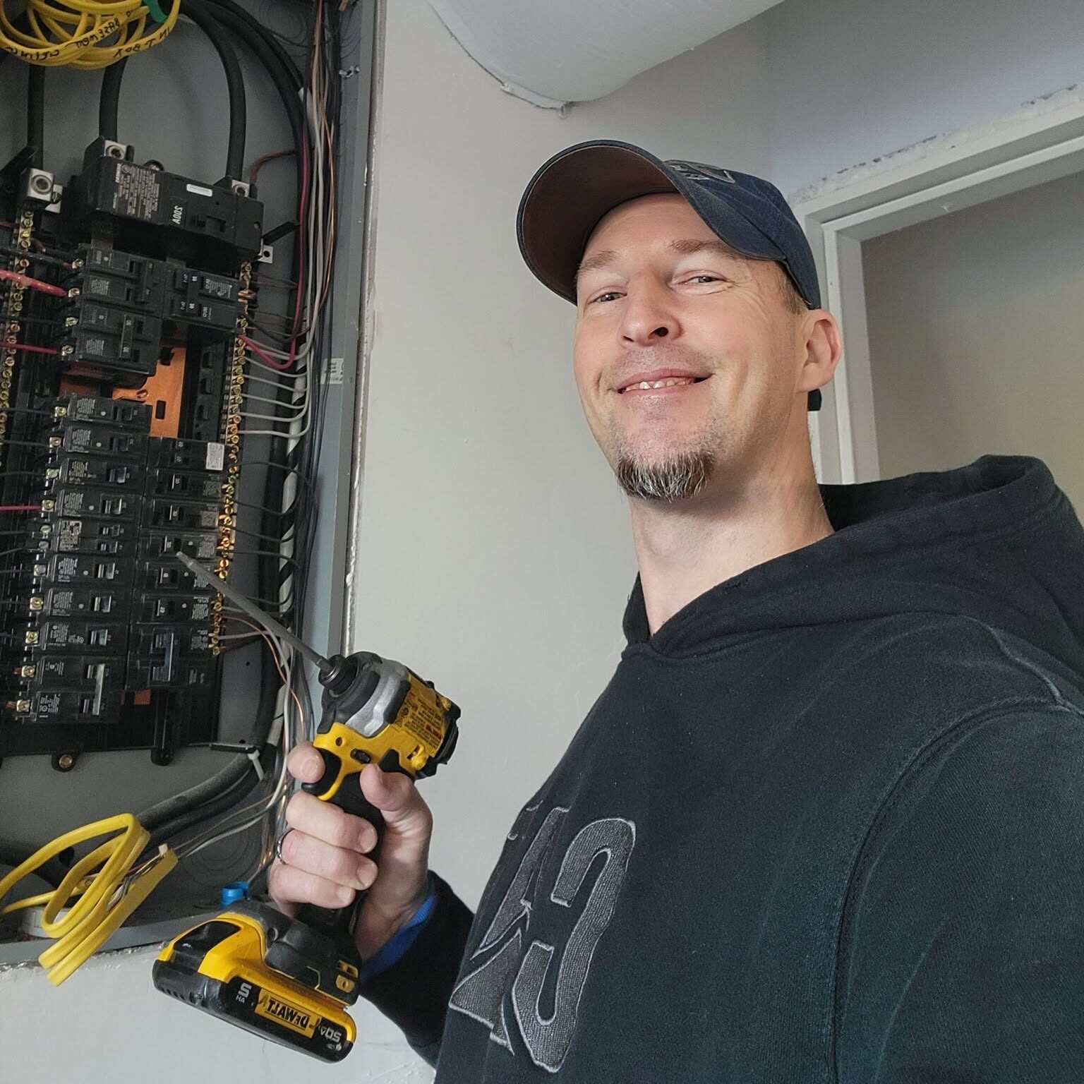 Licensed electrician troubleshooting a residential electrical panel during an electrical repair service.