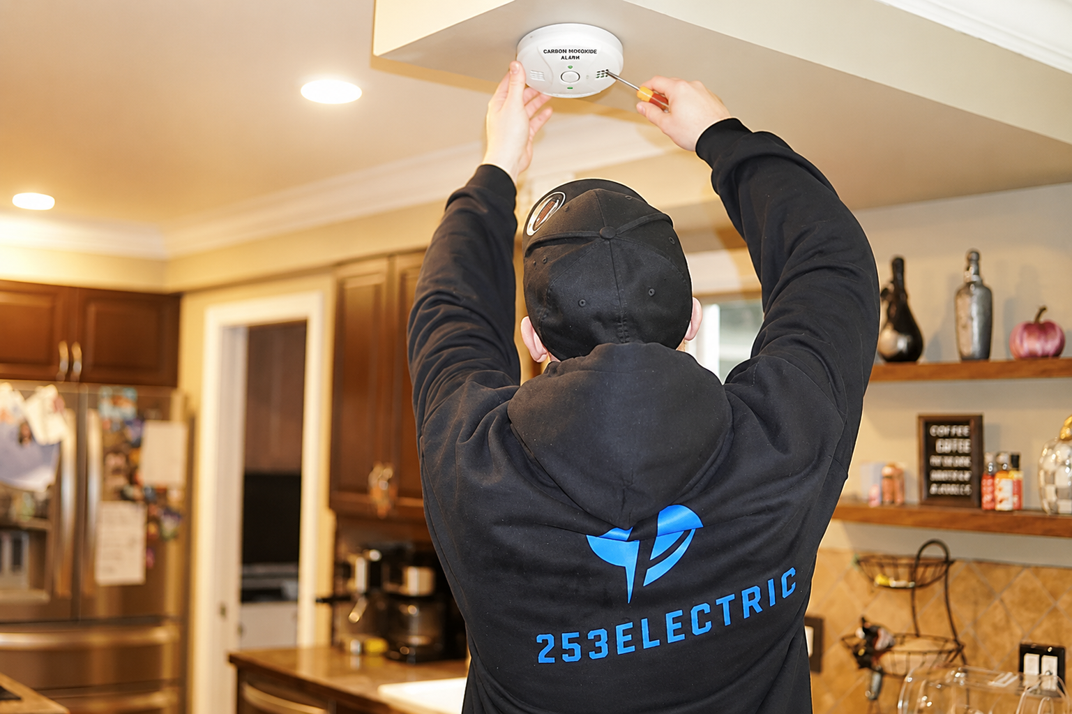 Licensed 253 Electric electrician installing a hardwired carbon monoxide detector in a Graham, WA home.