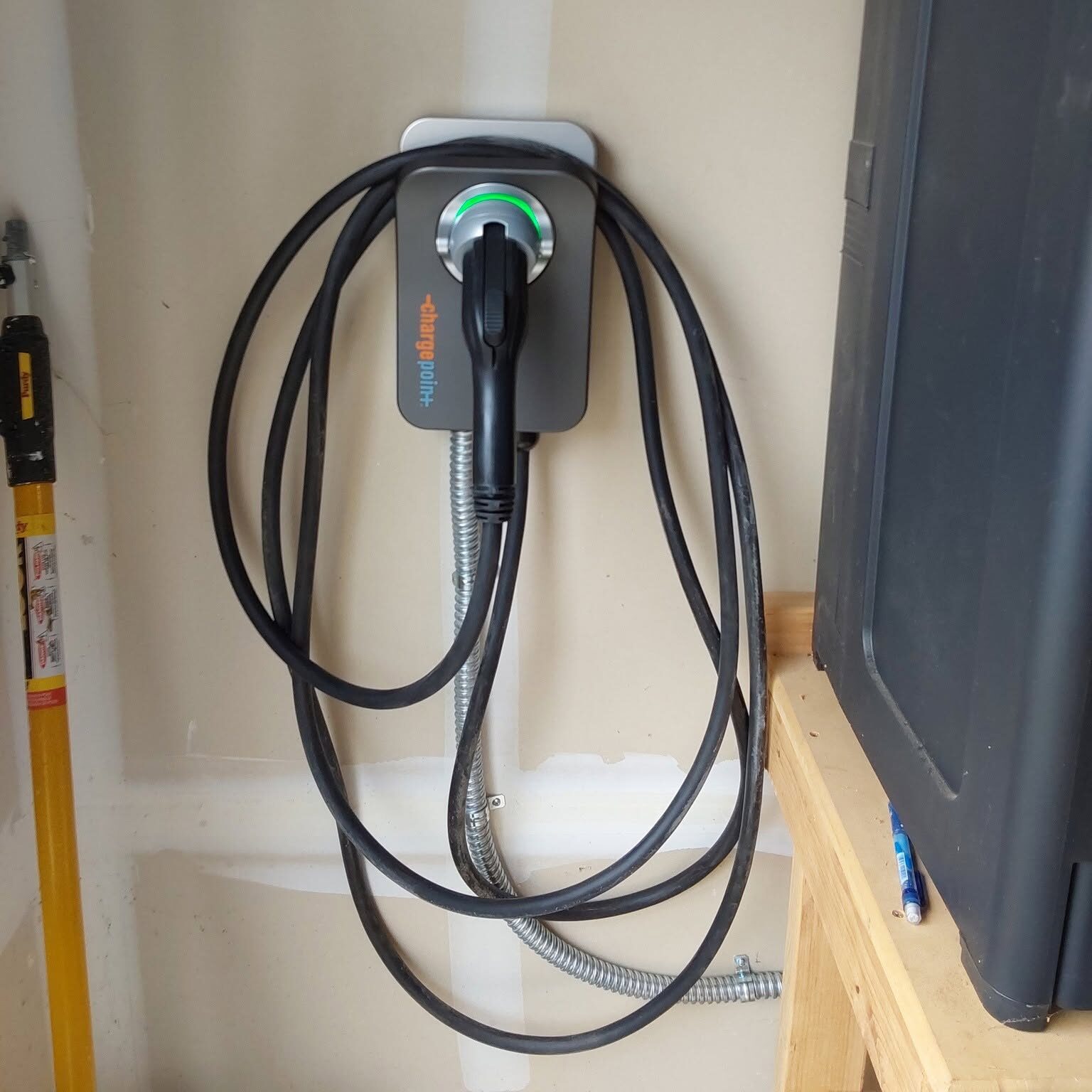Licensed electrician installing a Level 2 home EV charger for convenient electric vehicle charging.